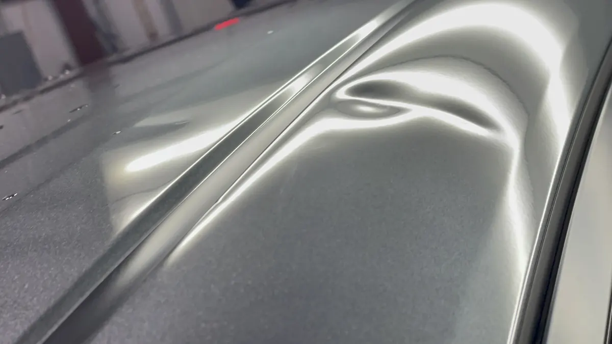 Crease dent across a body line under the PDR light board