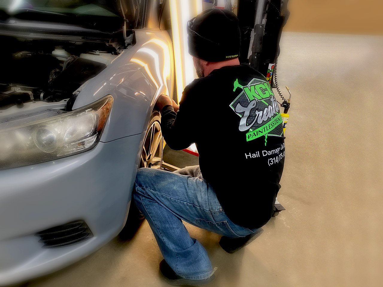 KCL Creations—Repair Tech removing dents with PDR