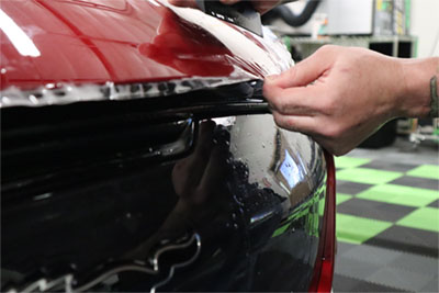 KCL Creations—Repair Tech removing dents with PDR