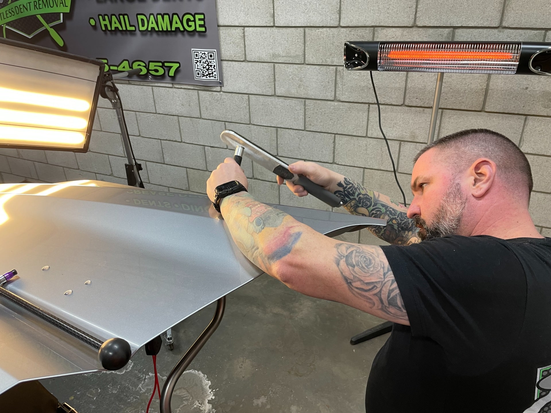 Technician inspecting hail damage for PDR at KCL Creations in Loveland, CO.
