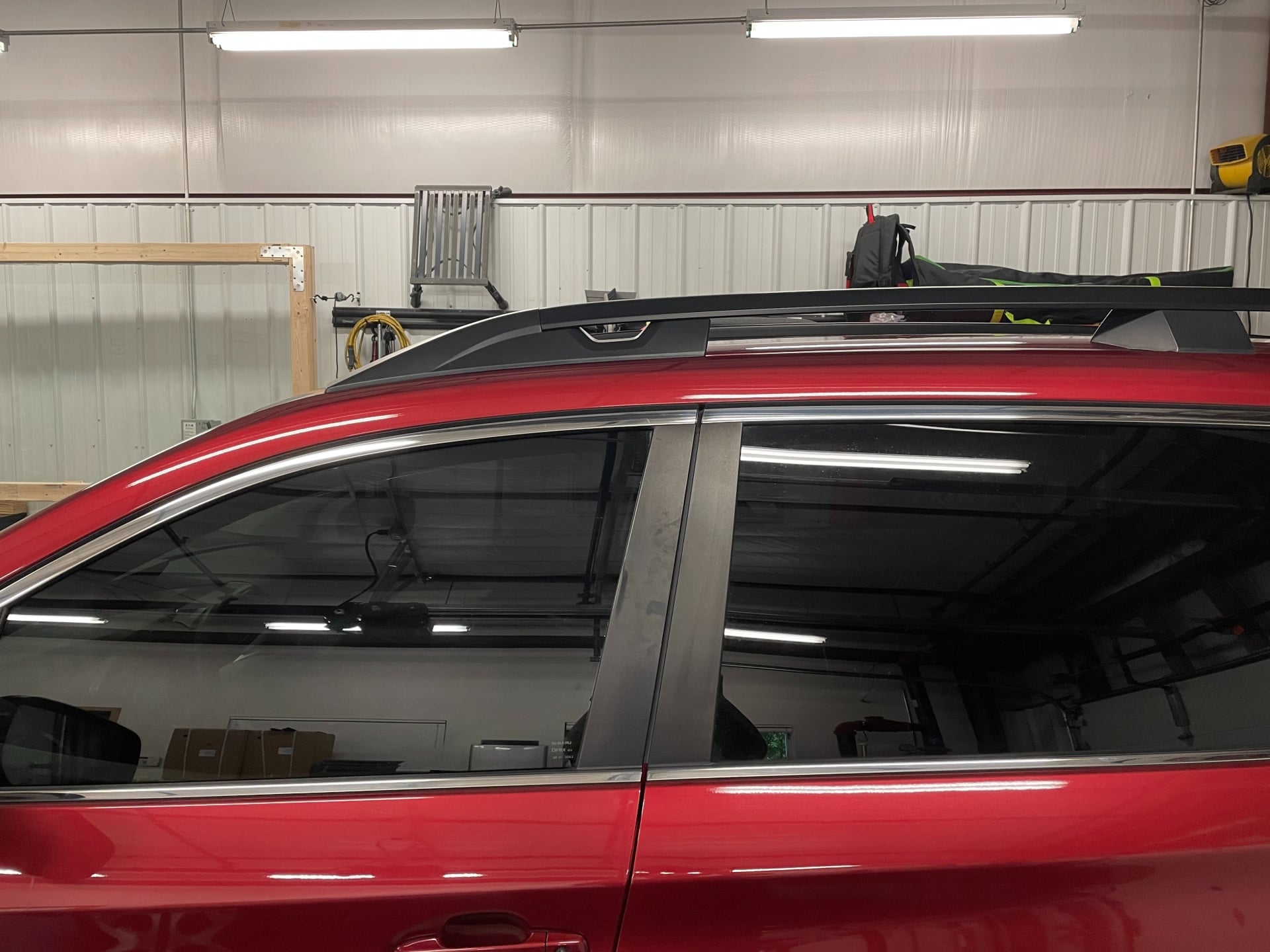 Technician installing ceramic window tint at KCL Creations in Loveland, CO.