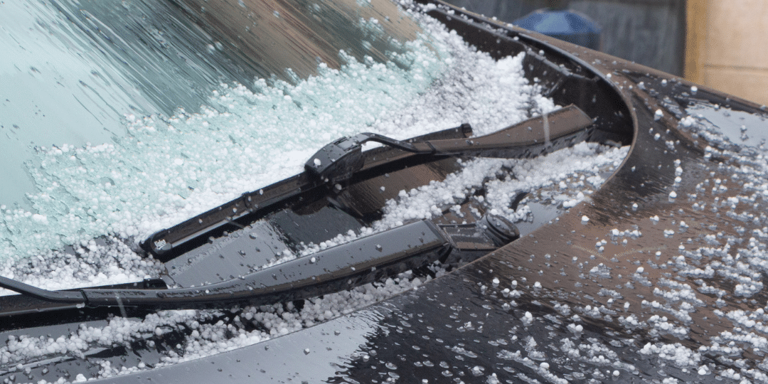 KCL Creations specialist inspecting a vehicle for hidden hail damage in Loveland.