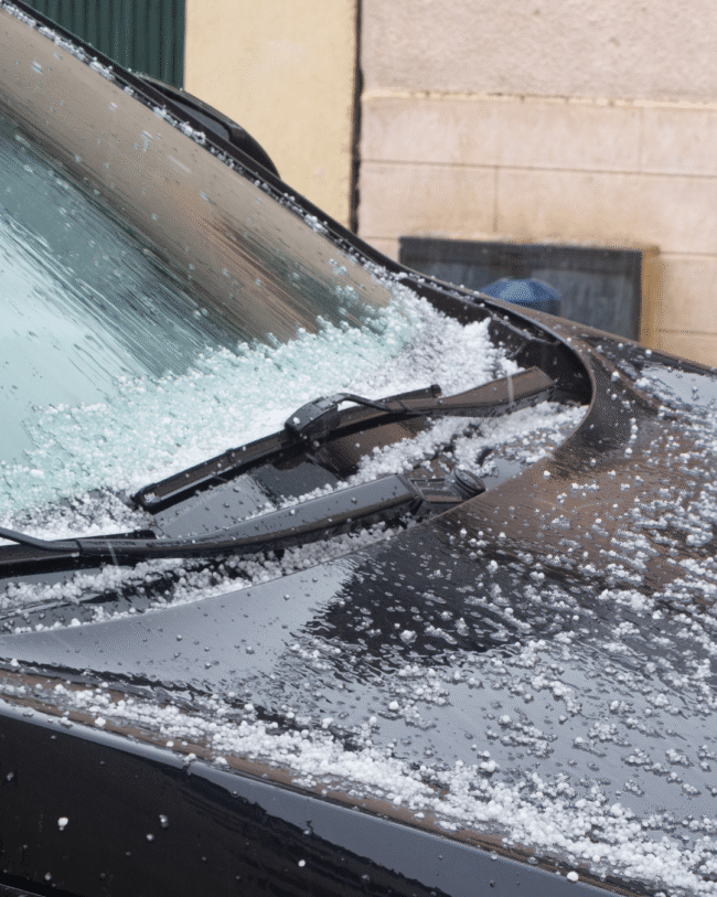 KCL Creations specialist inspecting a vehicle for hidden hail damage in Loveland.